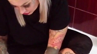 Tattooed blonde MILF washes her feet