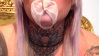 Tattooed blonde lady with a bubble gum
