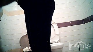 Busty MILF pissing in the toilet on the hidden camera