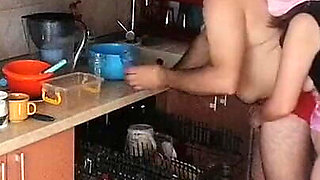 Couple Having Fun in the Kitchen. Sexy Wife Doing Chores in the House Naked