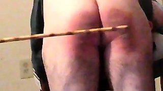 CANED AND STRAPPED OVER SPANKING STOOL