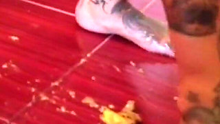 A banana is trampled by a blonde tattooed MILF