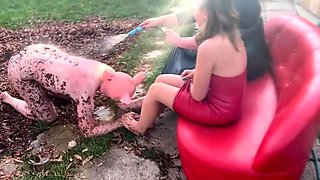 Foot slave being taught servitude and obedience outdoors