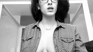 Busty babe with glasses plays with a sex toy on the webcam