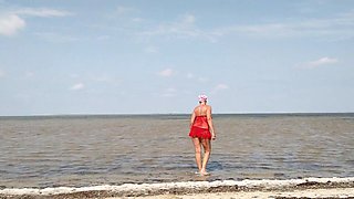 A Lonely Housewife by the Sea in a Red Net Takes off Her Panties and Bra and Shows Her Charms in Front of the Camera