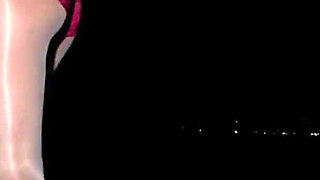Anna in white shiny pantyhose on the night beach