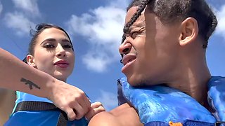 A black man fucks a juicy Cuban woman with fake big tits on jetski