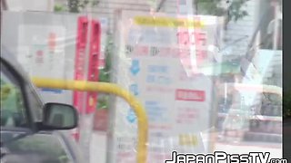 Ginger-haired Asian with brief hair is pissing on the streets