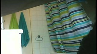 Shower voyeur spies on a sexy amateur girl with perky tits