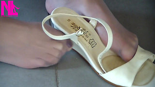 Nyllady Putting on Pantyhose and Footplay with Milk Colored Wedges