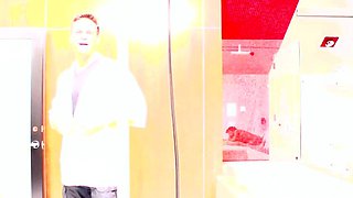 In a kitchen a sexy brunette playing with her big boobs