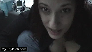 A busty brunette sucking his small dick off in the car