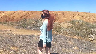 Girl undresses on a windy day